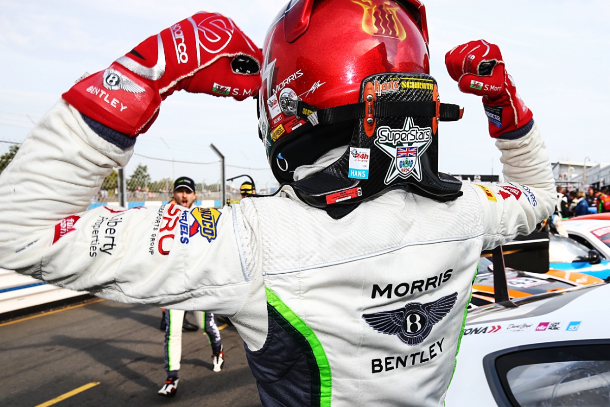 superstars5 BRDC SuperStar seb morris points to the programme logo on the back of his HANS device